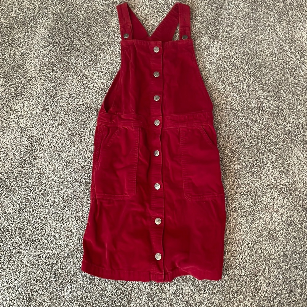 Maroon corduroy overall skirt with buttons and adjustable features